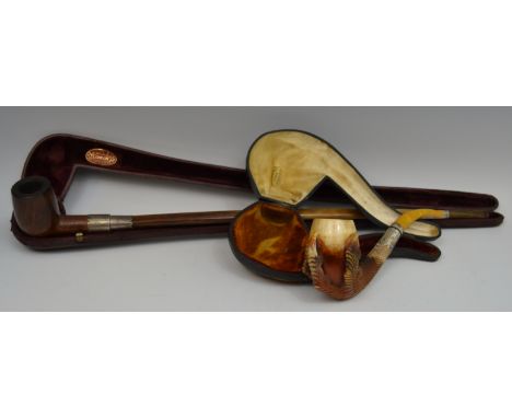 An early 20th century meerschaum pipe, the bowl being grasped by a claw, amber mouth piece, 18cm long, cased;  a Church Warde