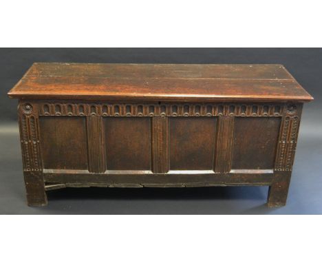 An 18th century rectangular blanket box, stop fluted frieze, four panel front, stile feet, 70cm high, 156cm wide, c.1720