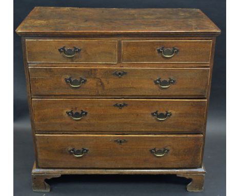 An early George III elm chest, rectangular top with moulded edge above two short and three long graduated cockbeaded drawers,