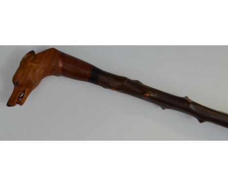 A blackthorn walking stick,  well  carved by Stan Randall,  with fox mask, 115cm long