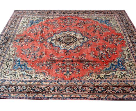 A Hamadan carpet,   in tones of red and blue, 405cm x 310cm 