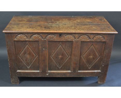 An 18th century oak rectangular blanket box, the three panel front  carved with lunettes, stile feet, 75cm high, 122cm wide, 