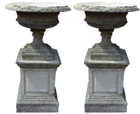 A pair of Regency design composition saucer-shaped garden urns, each with acanthus moulded everted rim, above a deep basket w