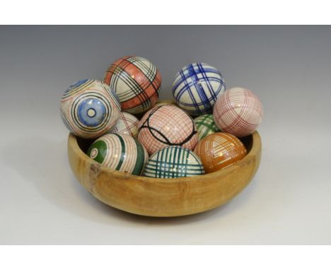 Eleven 19th century ceramic carpet bowls, various colours; a  treen bowl, 28cm diam