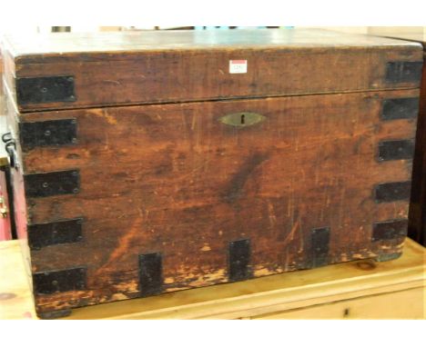 A late 19th century stained pine metal bound hinge topped trunk with iron end carry handles, width 77cmCondition report: Stru