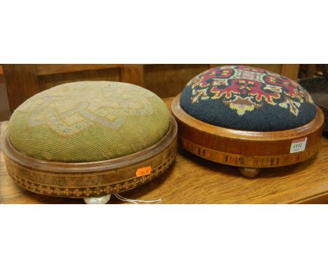 A near pair of late Victorian walnut and inlaid circular low foot stools, each with floral tapestry inset tops, dia. 28cm