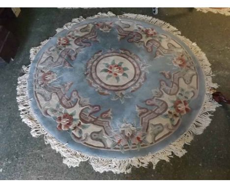 Blue and cream ground circular oriental thick pile carpet, with central circular rose lozenge with floral borders and tassell