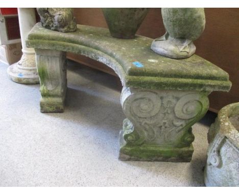 A weathered composition stone curved garden bench 40"w 