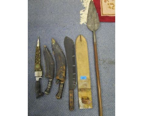 An Asian machete in leather scabbard, two kukris in scabbards, an Indian knife with horse's head handle and a gold wire woven