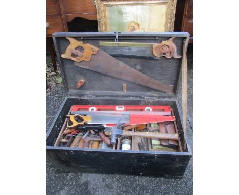 A vintage toolbox containing mixed woodworking tools to include saws, planes and other items 