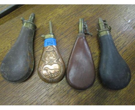 A group of four 19th century powder flasks to include a copper and brass flask with a dog and two birds surrounded by a scrol