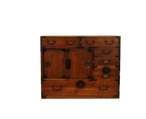 A Meiji period kiri wood cabinet (tansu) and a trunk (hasami bako)The cabinet metal bound, with rectangular top above two dra