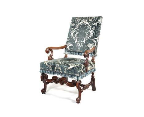A William and Mary walnut upholstered open armchairThe rectangular padded back above moulded arms with scroll terminals and s