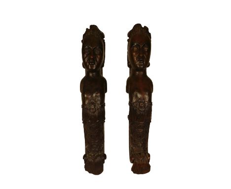 A pair of large 18th century oak carved architectural fragments of scrolling caryatidsOf bare breasted females, with guilloch