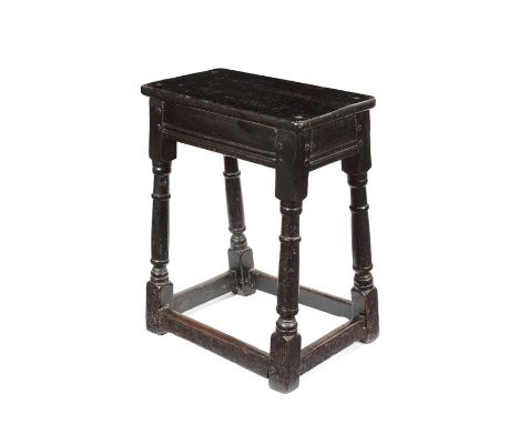 A 17th century and later ebonised oak joint stoolThe rectangular later top on ring turned legs joined by stretchers, 43cm wid
