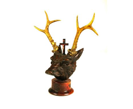 A group of various animal skulls, mostly 19th centuryComprising: an oak carved wolf’s head, with antlers and crucifix, on a t