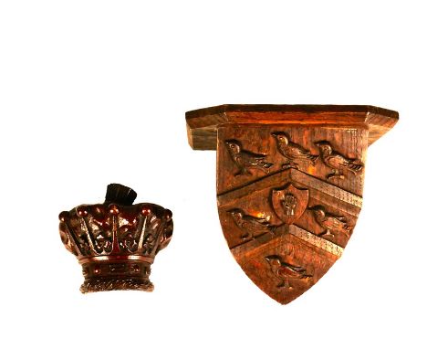 A group of 19th-century armorial carved and decorated shieldsComprising: a large carved oak shield surrounded by scrolling fo