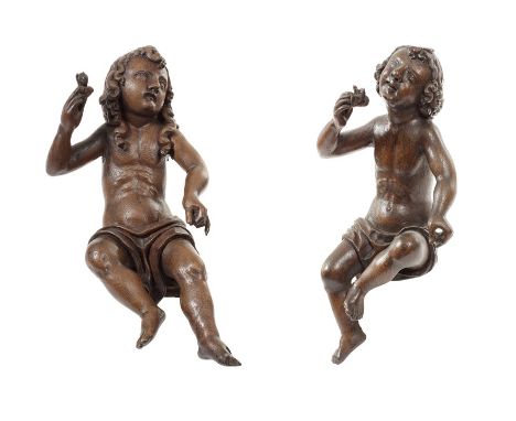 A pair of 18th/19th century Flemish carved oak architectural figures of seated angelsThe figures with long curled hair and dr