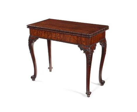A George III carved mahogany concertina-action card tableThe rectangular hinged top with riband and paterae carved edge enclo
