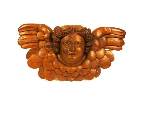 A group of architectural and other fragments decorated with amorini, 18th century and laterComprising: a large oak cherub mas