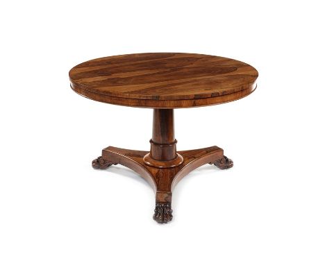 A small Regency rosewood centre or breakfast tableThe circular tilt top on a ring turned tapered column, moulded socle, quadr