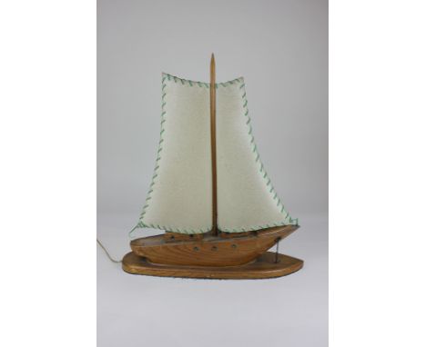 A model yacht table lamp with oak hull and base, the shade formed as two sails, 44cm by 39cm