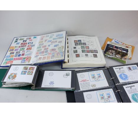 A collection of Swiss stamps and first day covers housed in four albums, with some loose