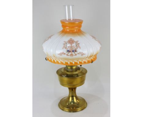 A brass oil lamp, marked Aladdin made in England, with white and orange glass shade and clear glass funnel, 52cm high
