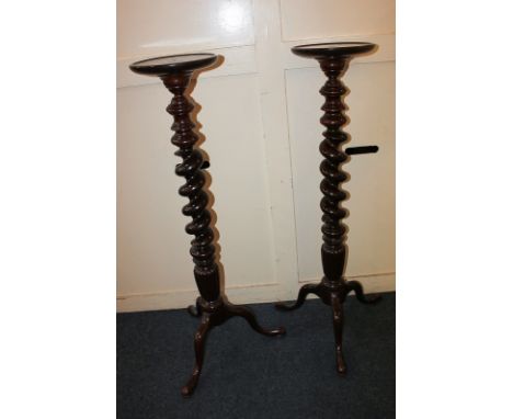 A pair of mahogany jardiniere stands with barley twist baluster stems on outswept tripod legs, 111cm high