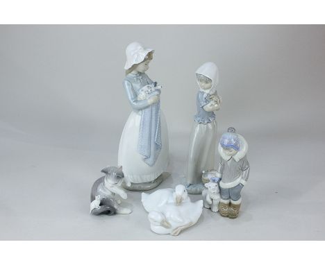 Two Nao porcelain figures of girls holding puppies, 25cm, two ducklings, a Lladro figure of a boy and polar bear, and a cat a