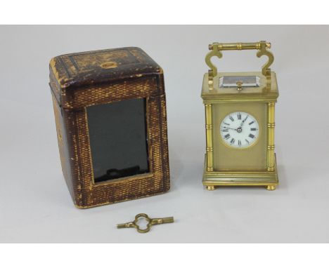 A French gilt brass and bevelled glass cased carriage clock, the circular dial with Roman numerals and gilt surround, the rep