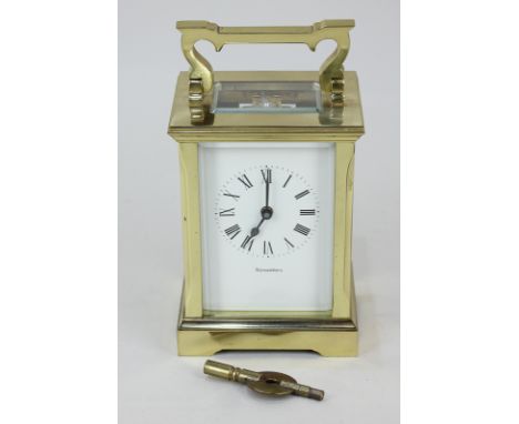 A gilt brass and bevelled glass cased carriage clock, the rectangular dial with Roman numerals, marked Alexanders, 14.5cm hig
