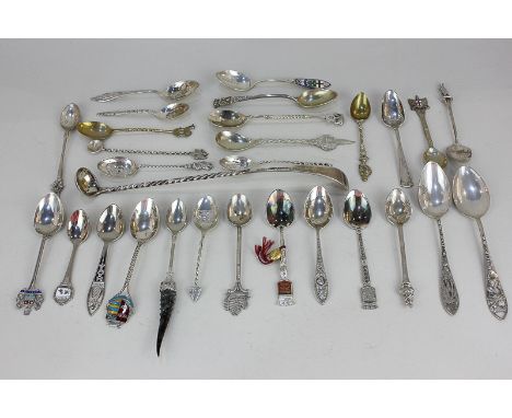 A collection of Continental white metal, silver plated and brass commemorative spoons, together with three English silver tea