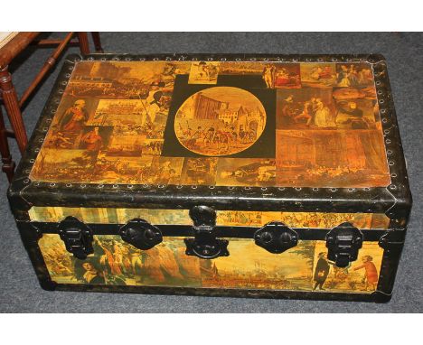 A metal bound trunk with hinged lid and leather carry handles, decorated in decoupage with classic battle scenes and military
