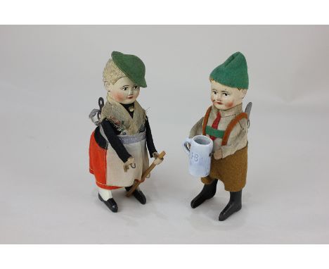 Two Schuco clockwork tinplate and plush toys, comprising a boy holding a ceramic beer stein, dressed in green hat, beige shir