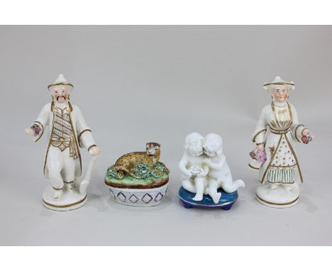 A pair of pottery figures of a man and woman in Chinese garb holding flowers, 13cm high, together with an oval pot and cover 