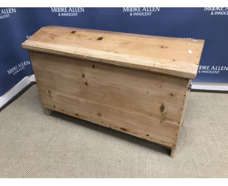 A Continental pine trunk or coffer with shaped lid and carrying handles, raised on plank end supports, 109 cm wide x 50 cm de