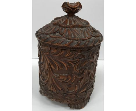 A 19th Century Norwegian carved acanthus decorated cylindrical pot and cover (probably tea caddy), raised on three foliate fe