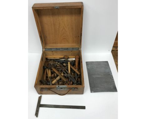 An oak case containing a selection of various engraving tools including chisels, hammers, cutting tools, various and an engra