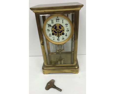 A circa 1900 French four glass brass cased mantel clock in the manner of Marti, the circular dial with Arabic numerals, raise