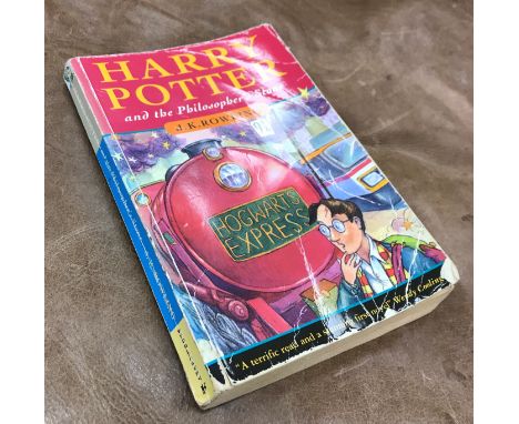 J K ROWLING "Harry Potter and The Philosopher's Stone", first edition, paperback, published 1997 by Bloomsbury, bearing spell