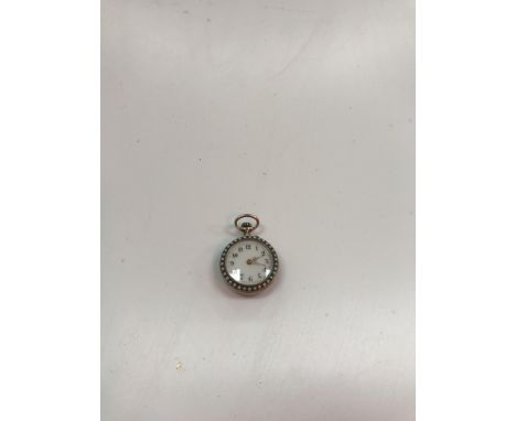 A late 19th/early 20th Century 9 carat gold cased ladies fob watch with seed pearl decoration, the enamel dial set with Arabi