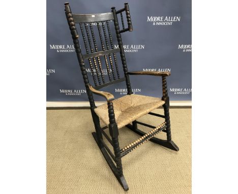 A black stained ash and beech rocking chair in the style of Ernest Gimson for Robert Weir Schultz circa 1890, with bobbin tur