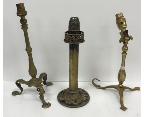 Two circa 1900 brass train / ship lamps, the pedestals raised on tripod feet, each with a single screw hole to one foot, toge