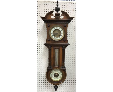 A circa 1900 walnut cased Vienna style eight day wall clock with mercury thermometer and aneroid barometer, the clock dial wi