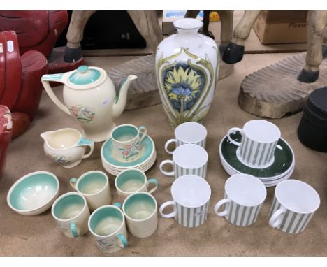 A Susie Cooper coffee service comprising coffee pot, milk jug, sugar bowl and six coffee cans and saucers with floral decorat