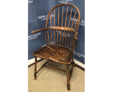 A 19th Century West Country ash and elm stick back elbow chair with D shaped saddle seat on turned legs united by stretchers,