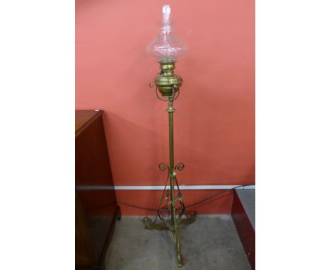 An Arts and Crafts brass and wrought iron standard oil lamp, manner of W.A.S. Benson