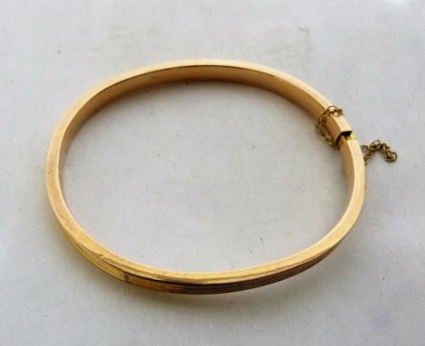 A hinged bangle in gold marked 14ct. 6.6g