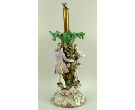 A large 19th century Meissen centre piece later converted to a lamp, formed as a courting couple chasing one another around a